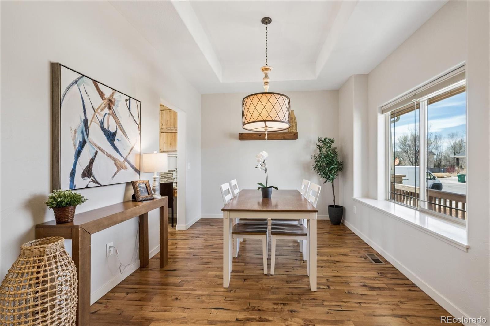 3674 Watts Street Timnath, CO 80547 - Photo 5 of 50 a view of a livingroom with furniture wooden floor a chandelier