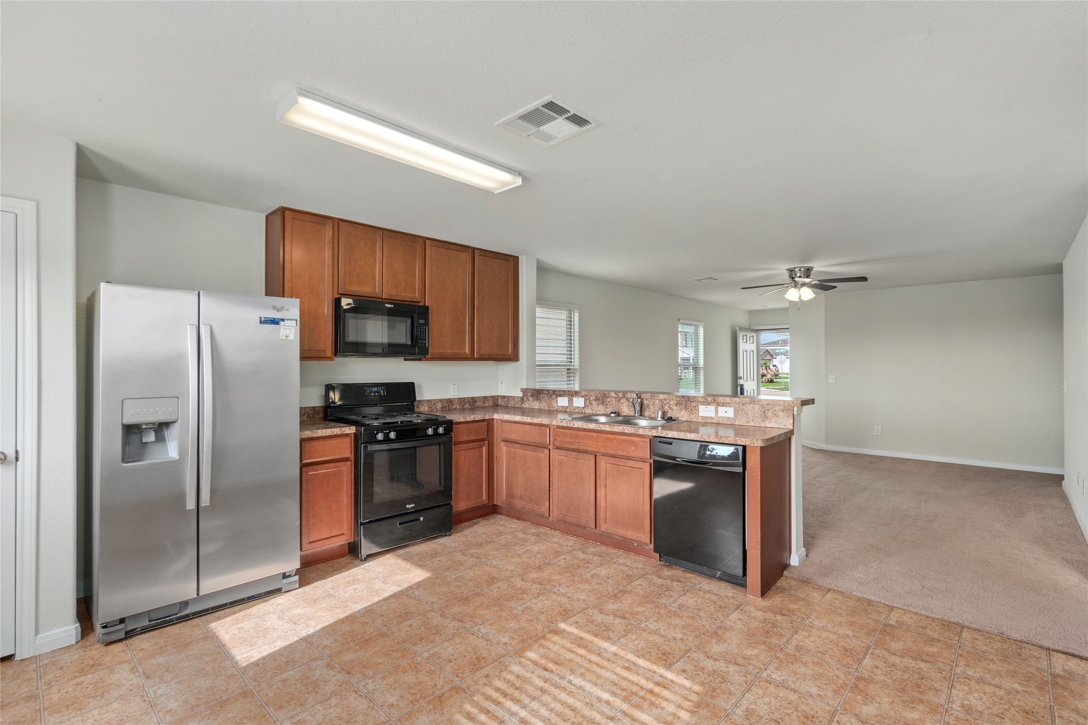 1323 Pease River Lane Rosenberg, TX 77471 - Photo 11 of 31 a kitchen with stainless steel appliances granite countertop a stove refrigerator sink and dishwasher