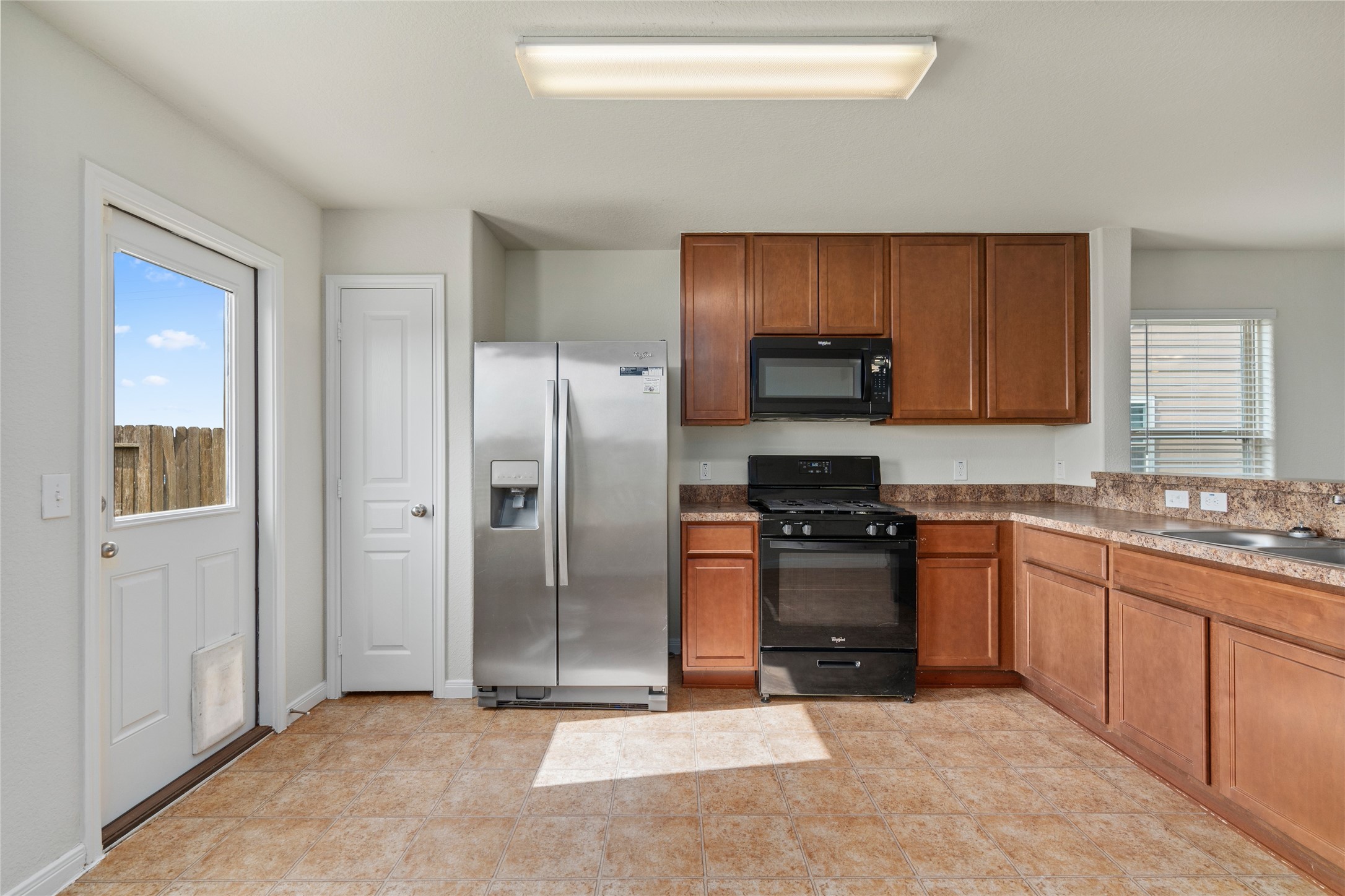 1323 Pease River Lane Rosenberg, TX 77471 - Photo 12 of 31 a kitchen with stainless steel appliances granite countertop a refrigerator stove and sink