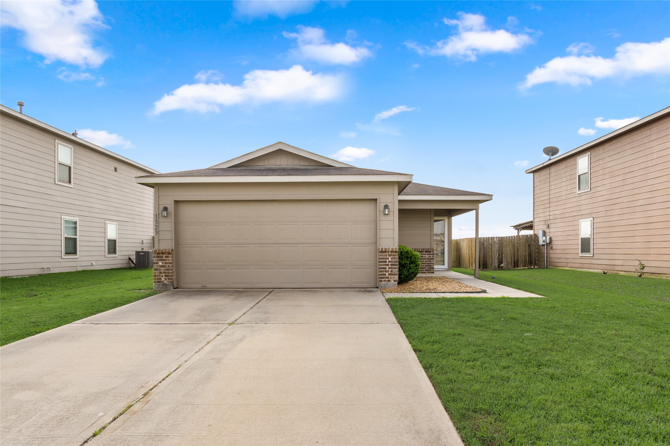 1323 Pease River Lane Rosenberg, TX 77471 - Photo 3 of 31 a front view of a house with a yard and garage