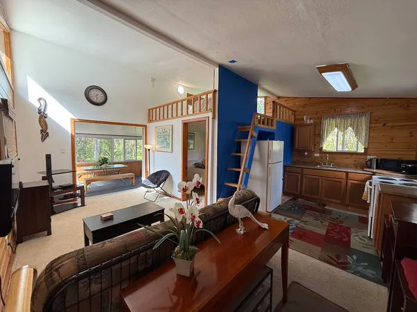 a room with furniture flat screen tv and windows