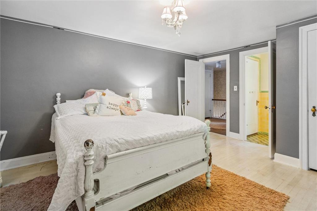 346 Midway Road Pittsburgh, PA 15216 - Photo 30 of 47 a spacious bedroom with a bed and a chandelier