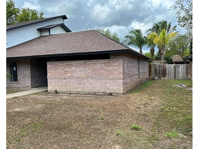 1512 Falcon Avenue McAllen, TX 78504 - Photo 2 of 14 View of home's exterior with brick siding and roof with shingles