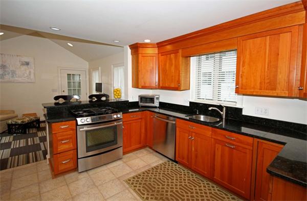 23 Pine Plain Road Wellesley, MA 02481 - Photo 6 of 26 a kitchen with stainless steel appliances granite countertop a sink stove and refrigerator