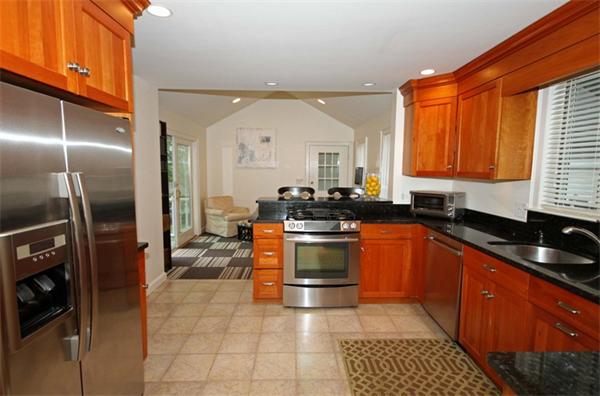 23 Pine Plain Road Wellesley, MA 02481 - Photo 7 of 26 a kitchen with stainless steel appliances granite countertop a stove a sink and a refrigerator