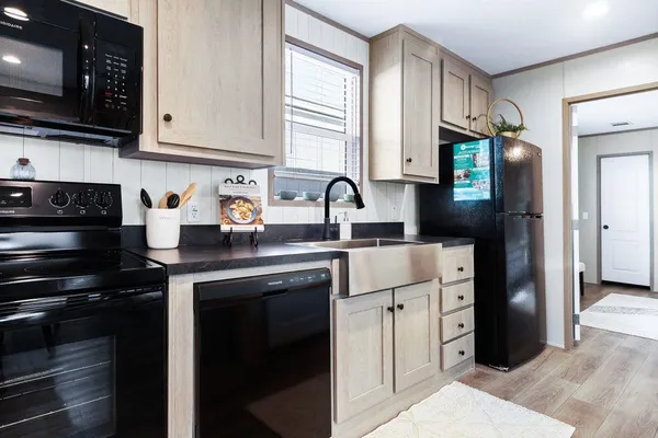 a kitchen with stainless steel appliances granite countertop a refrigerator sink and stove