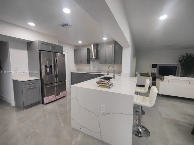 a kitchen with refrigerator and cabinets