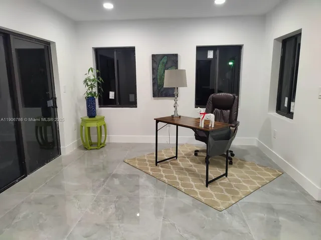 an empty room with windows and table