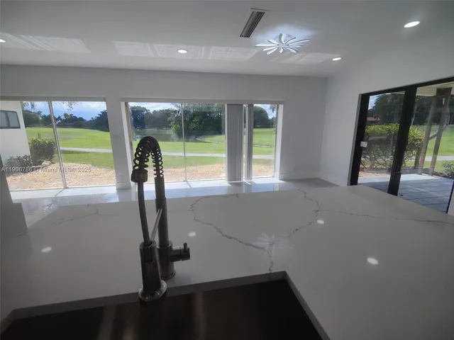 wooden view of an empty room with a floor to ceiling window and an outdoor view