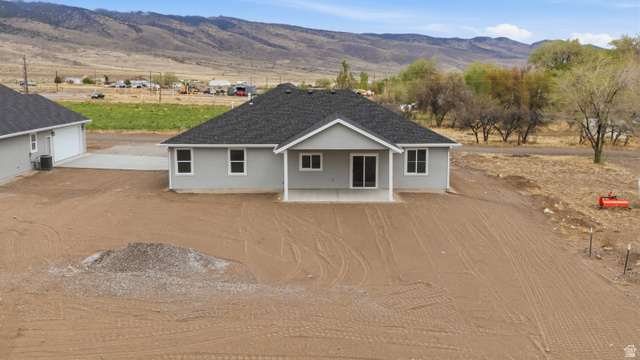 157 West 100 South Joseph, UT 84739 - Photo 2 of 30 Ranch-style home with a patio area, a mountain view, driveway, and a garage