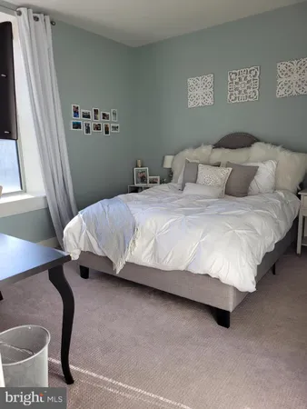 a living room with furniture a large window and a flat screen tv