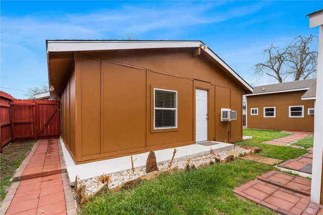 a backyard of a house with barbeque oven