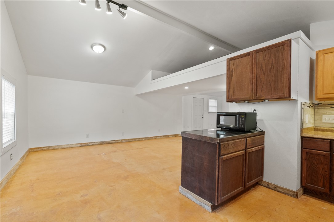 4414 Diane Drive, Unit 1B Austin, TX 78745 - Photo 5 of 15 a kitchen with stainless steel appliances granite countertop a stove a sink and a microwave