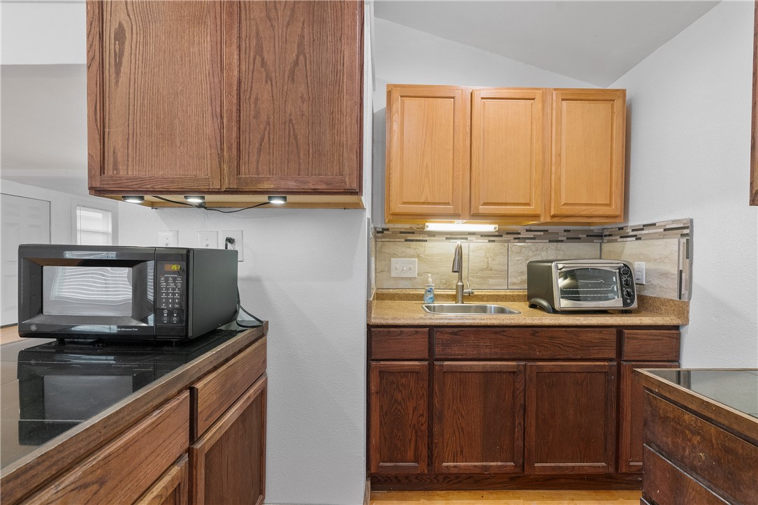 4414 Diane Drive, Unit 1B Austin, TX 78745 - Photo 7 of 15 a kitchen with stainless steel appliances granite countertop a stove a sink and a microwave