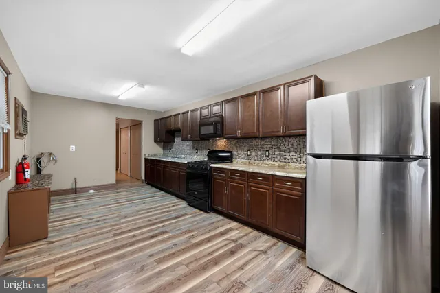 a kitchen with stainless steel appliances granite countertop a refrigerator sink and cabinets