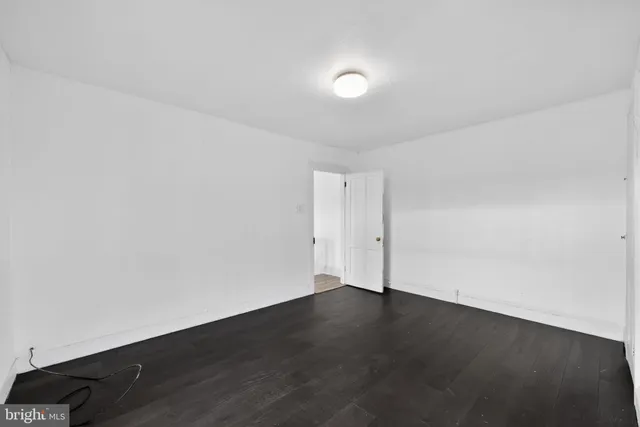 a view of an empty room and wooden floor