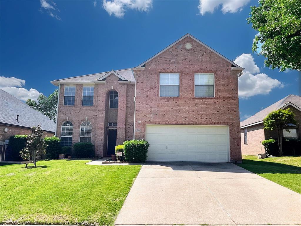 3304 Paradise Valley Drive Plano, TX 75025 - Photo 1 of 38 Traditional home with concrete driveway, an attached garage, brick siding, and a front lawn