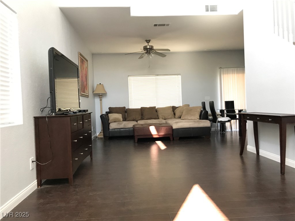 5423 Dancing Bear Drive Las Vegas, NV 89113 - Photo 15 of 18 Living area featuring a ceiling fan and dark wood