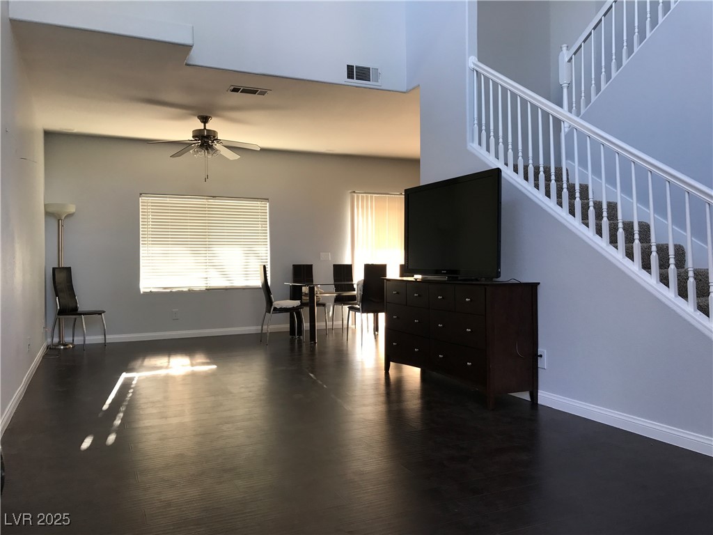 5423 Dancing Bear Drive Las Vegas, NV 89113 - Photo 3 of 18 Living room with a ceiling fan, stairway, and wood
