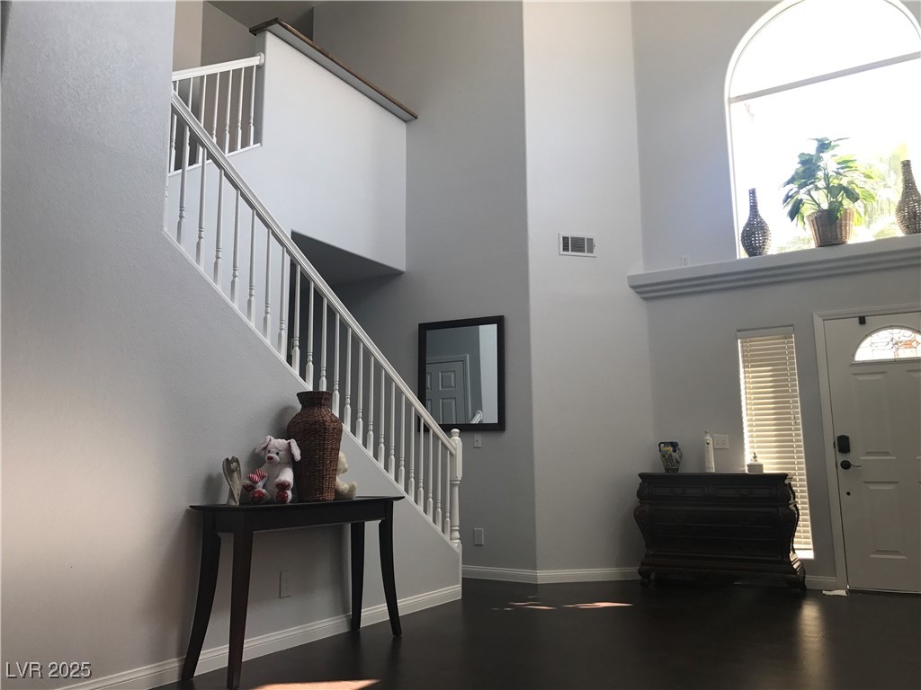 5423 Dancing Bear Drive Las Vegas, NV 89113 - Photo 5 of 18 Entryway featuring a high ceiling, stairs, healthy
