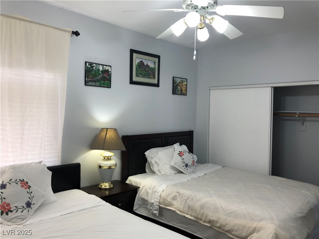 5423 Dancing Bear Drive Las Vegas, NV 89113 - Photo 6 of 18 Bedroom featuring a closet and a ceiling fan