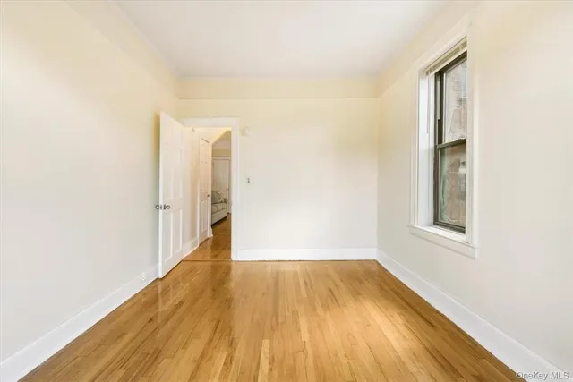 a view of a room with wooden floor and a window