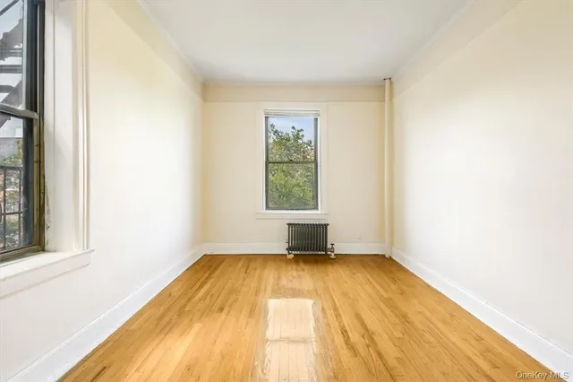 a view of a room with wooden floor and window