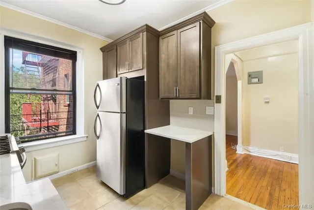 a kitchen with stainless steel appliances a refrigerator and a stove