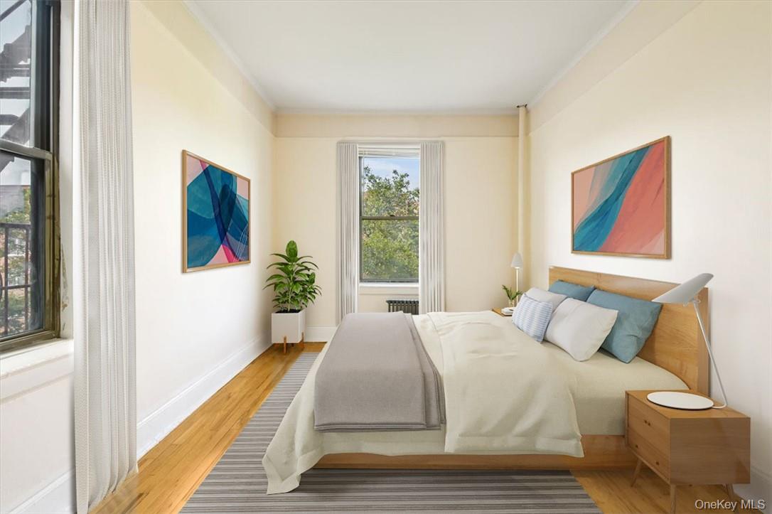 663 Locust Street, Unit 4A Mount Vernon, NY 10552 - Photo 2 of 31 a bedroom with a bed and a painting on the wall