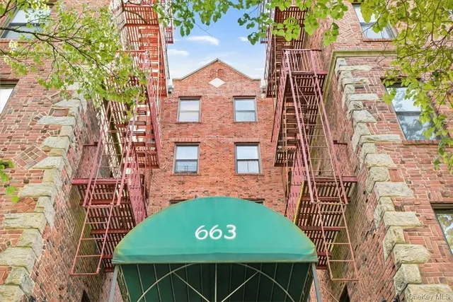 a view of a brick wall with a large window