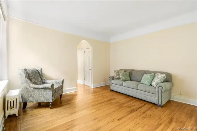 a living room with couches and a coffee table with wooden floor