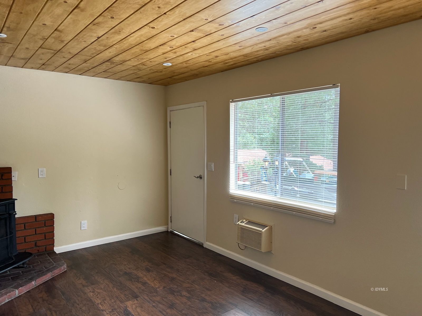 25840 Highway 243, Unit 24 Idyllwild, CA 92549 - Photo 3 of 7 an empty room with wooden floor and windows