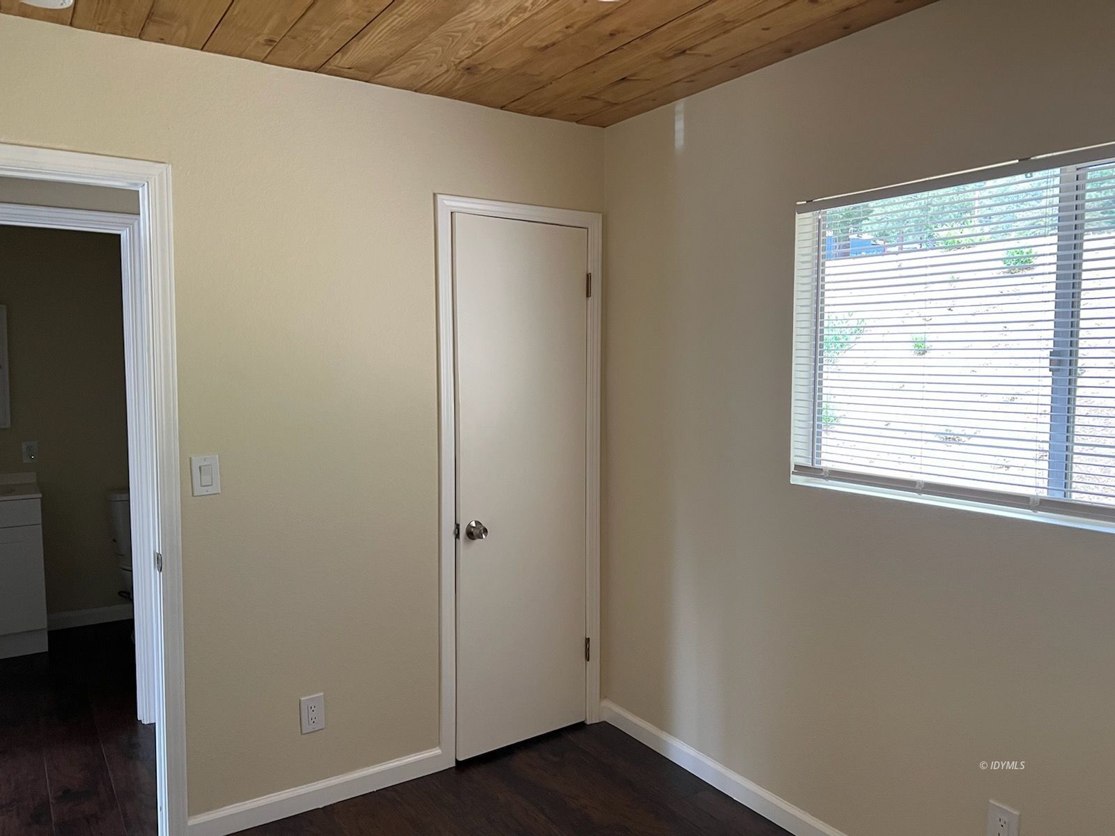 25840 Highway 243, Unit 24 Idyllwild, CA 92549 - Photo 5 of 7 a view of an empty room with wooden floor and a window
