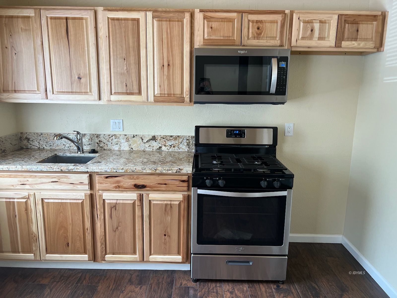 25840 Highway 243, Unit 24 Idyllwild, CA 92549 - Photo 7 of 7 a kitchen with stainless steel appliances granite countertop white cabinets and a stove top oven