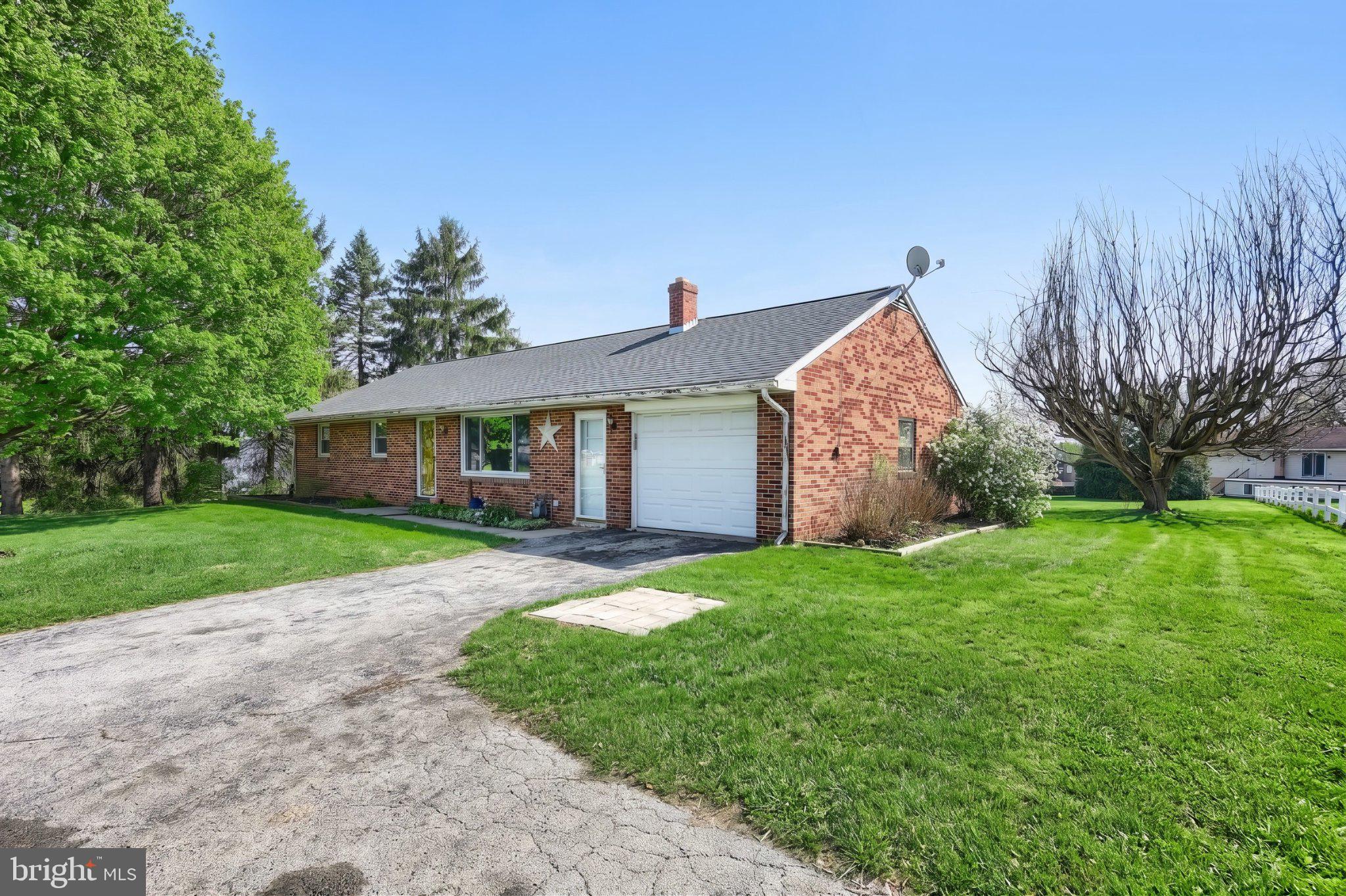 860 Witmer Road York, PA 17406 - Photo 4 of 40 Charming brick home with lush greenery.