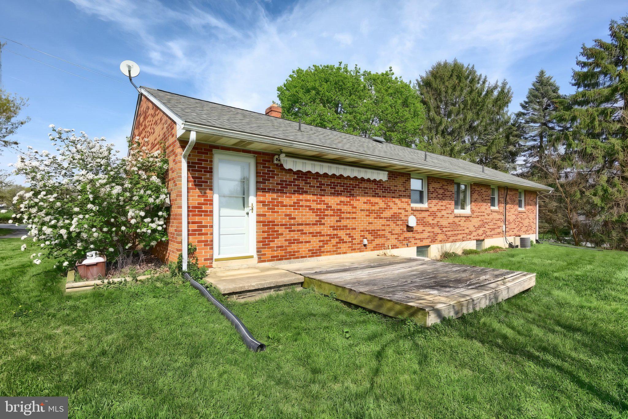 860 Witmer Road York, PA 17406 - Photo 6 of 40 Charming brick home with lush greenery.