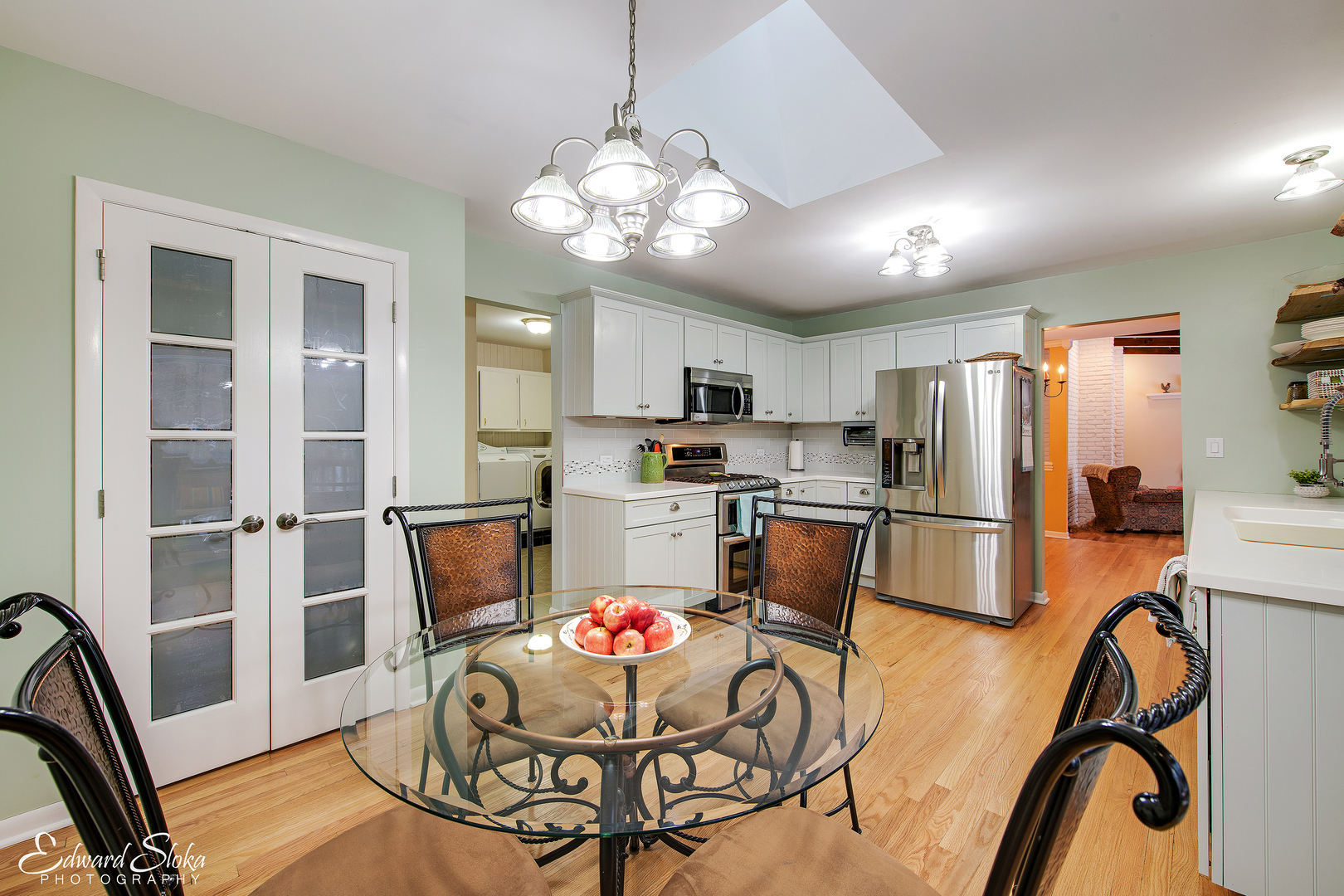 178 Stonegate Road Trout Valley, IL 60013 - Photo 12 of 24 a kitchen with stainless steel appliances kitchen island granite countertop a refrigerator a stove a microwave oven a dining table and chairs with wooden floor