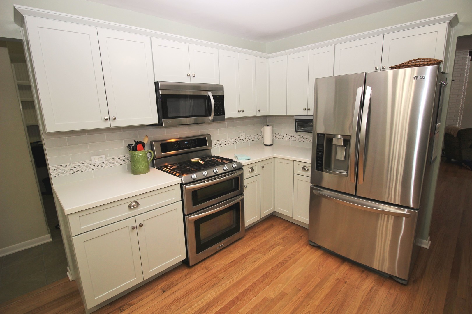 178 Stonegate Road Trout Valley, IL 60013 - Photo 9 of 24 a kitchen with a refrigerator stove and white cabinets