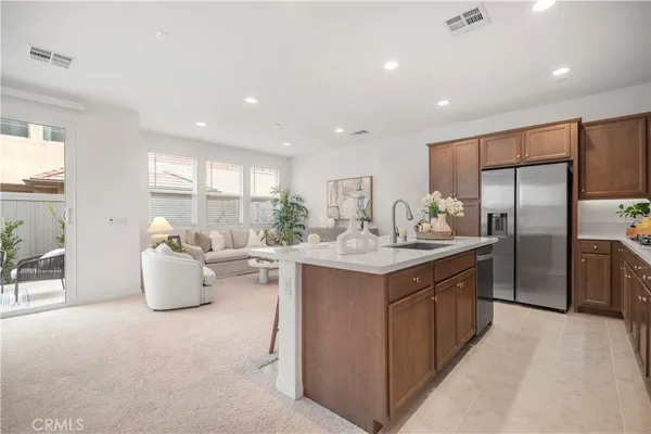 a kitchen with sink cabinets and living room view