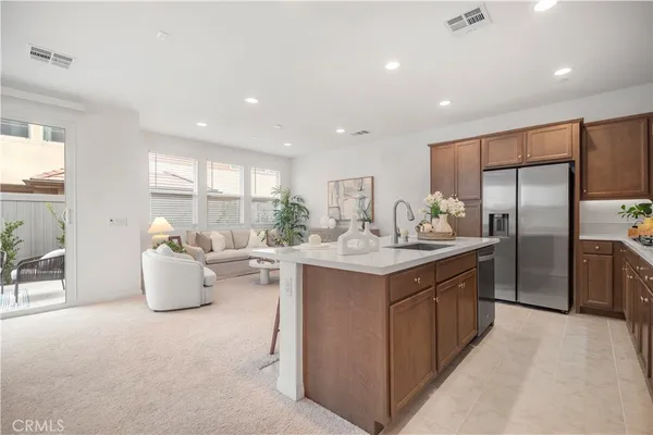 a kitchen with sink cabinets and living room view