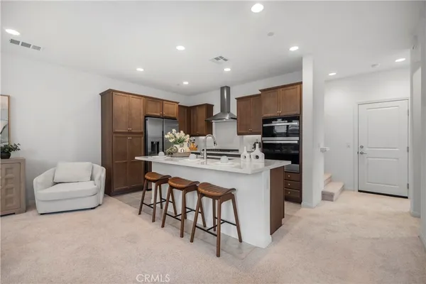 a kitchen with a refrigerator and a stove top oven