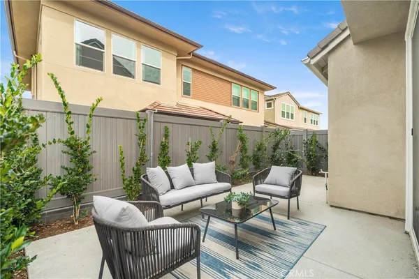 a view of a patio with couches and potted plants