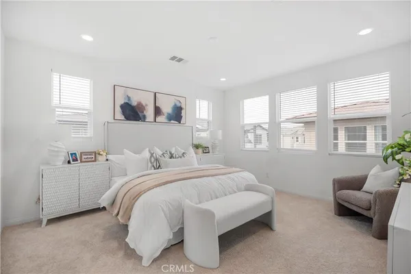 a bedroom with a bed and a couch
