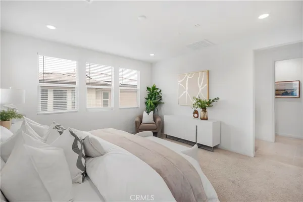 a bedroom with a large bed and a chandelier