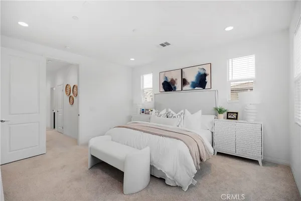 a bedroom with a bed and a painting on the wall