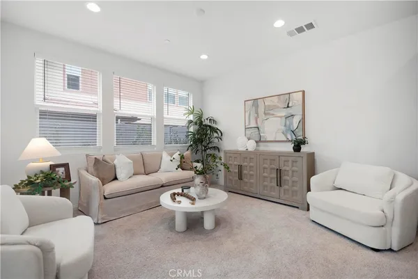 a living room with furniture and a large window
