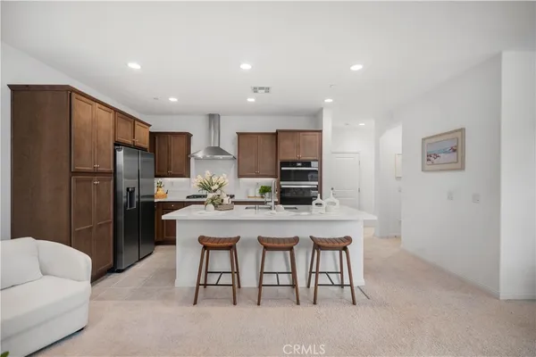 a kitchen with stainless steel appliances a refrigerator and a stove top oven