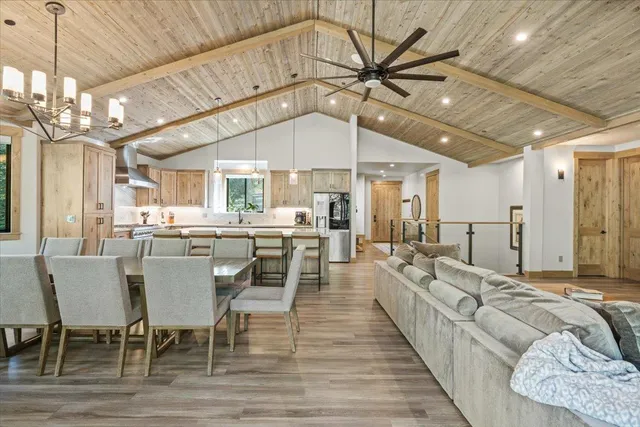a bedroom with a large bed and a chandelier fan