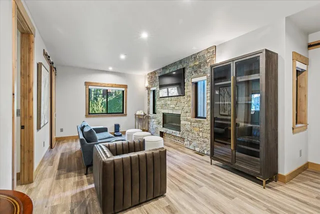 a bathroom with a granite countertop sink a toilet a mirror and shower