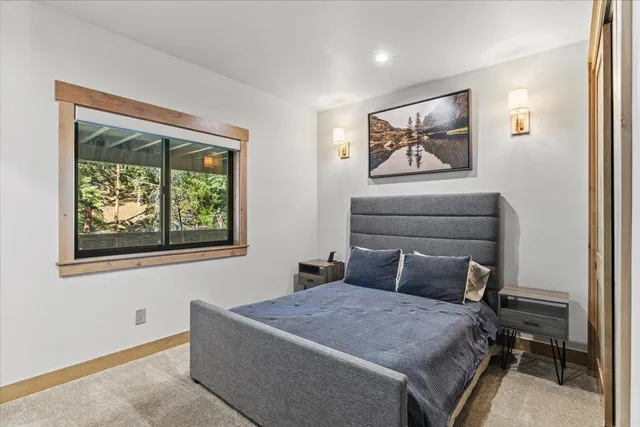 a bathroom with a double vanity sink toilet mirror and shower